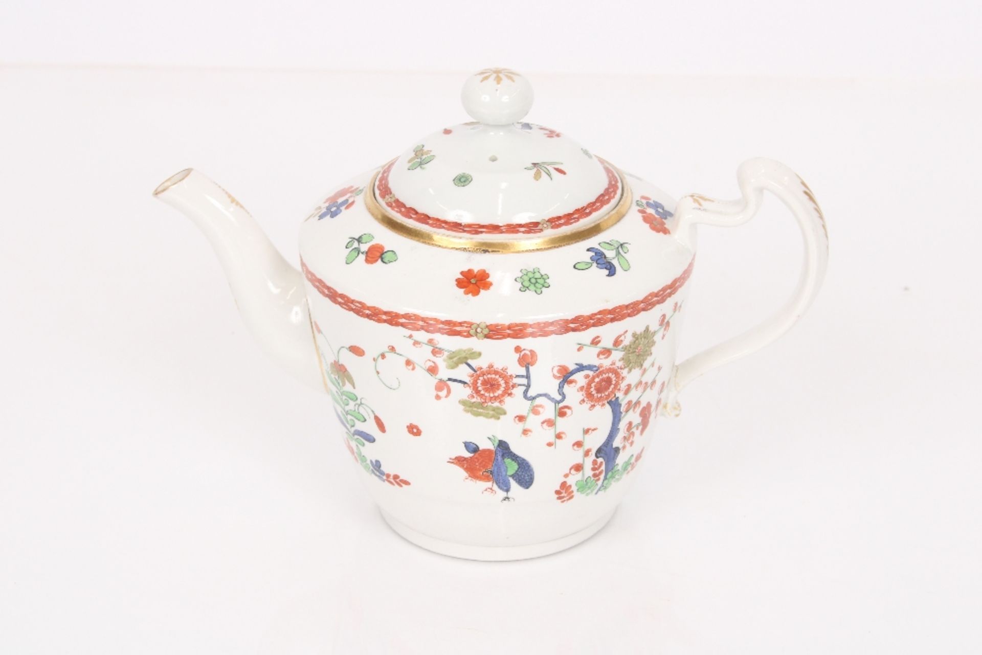 A 19th century English porcelain teapot, decorated in the Chinese manner with floral decoration