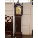 An oak longcase clock with arched hood, brass dial