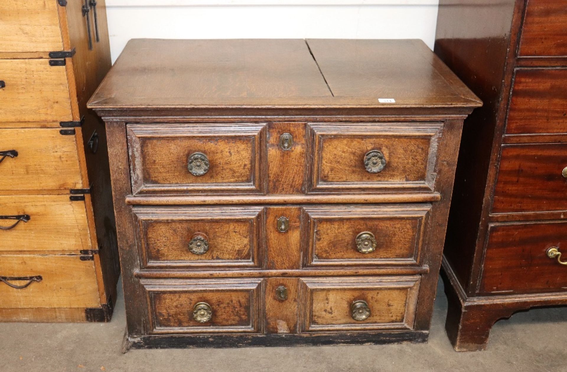 An 18th century oak chest fitted three long drawers, with moulded panel, fronts and sides, 94cm