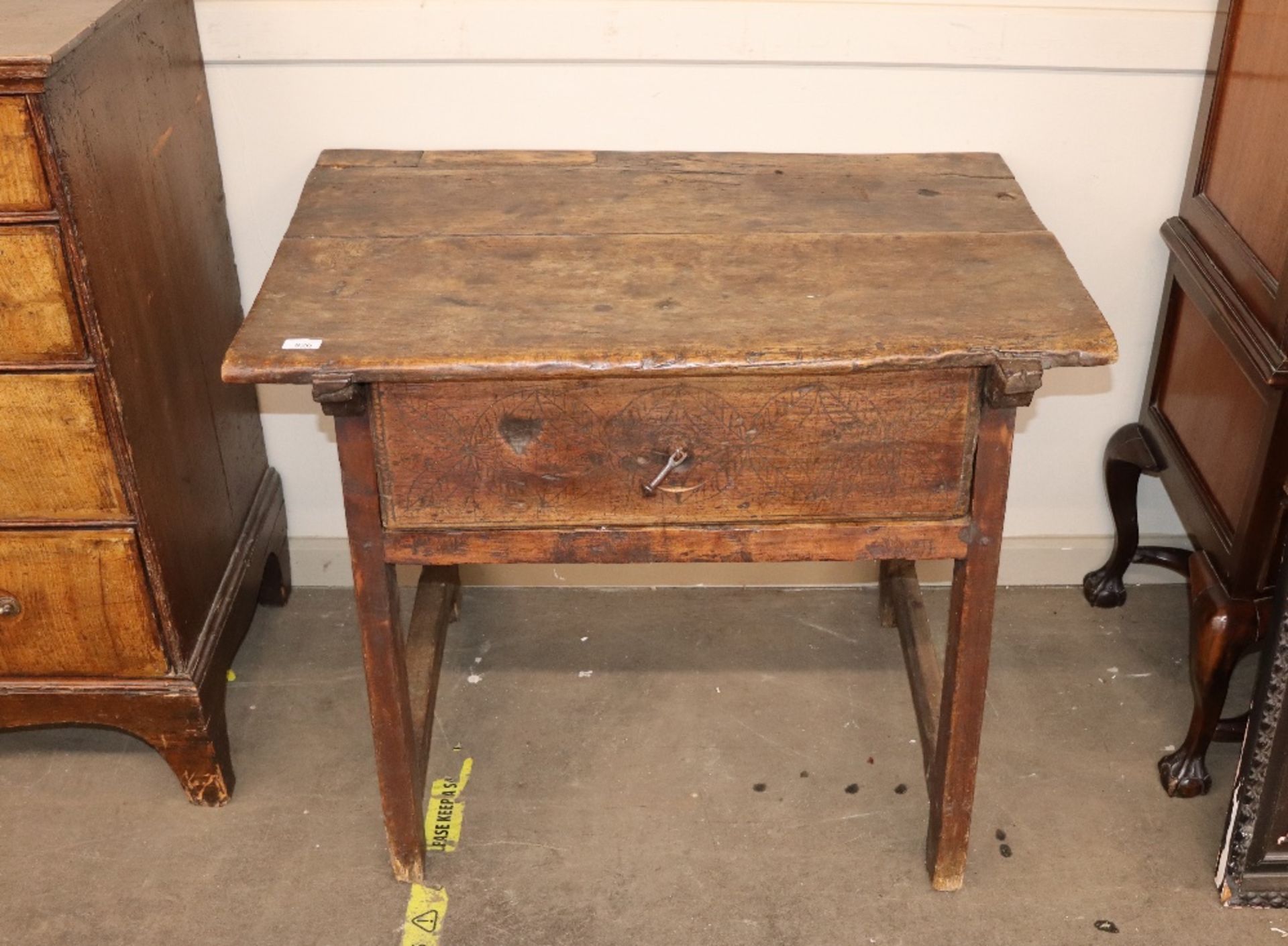 An antique oak and elm side table fitted with a si