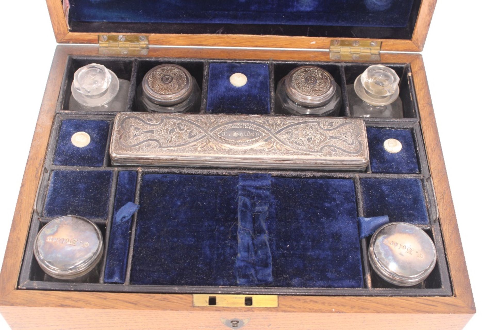 A 19th century golden oak, cased vanity box containing various bottles and tidy jars with foliate - Image 3 of 3