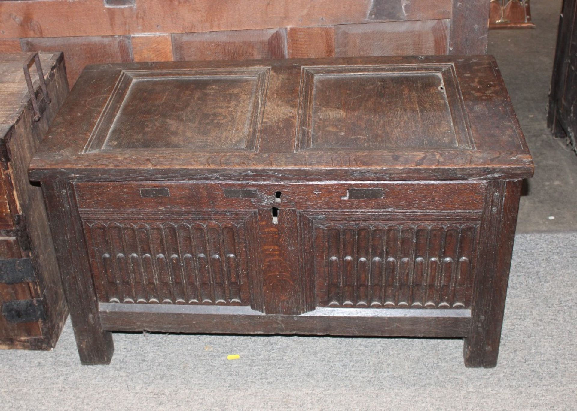 An 19th century oak coffer with carved front panel