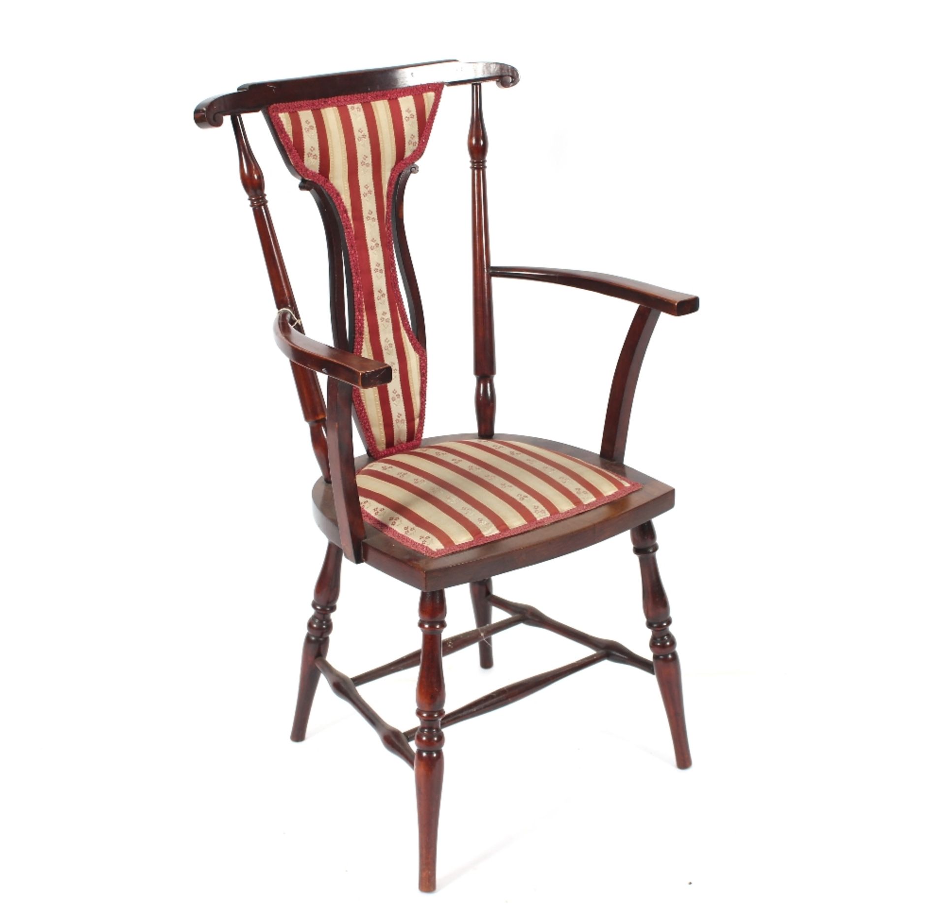 An Edwardian mahogany salon elbow chair with regen