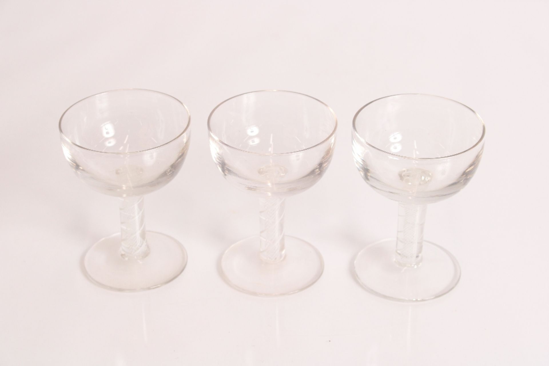 Three saucer shaped glasses with air and cotton tw
