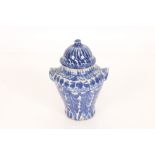 A Middle Eastern pottery vase and cover of baluster form with blue sponge decoration, 21cm high