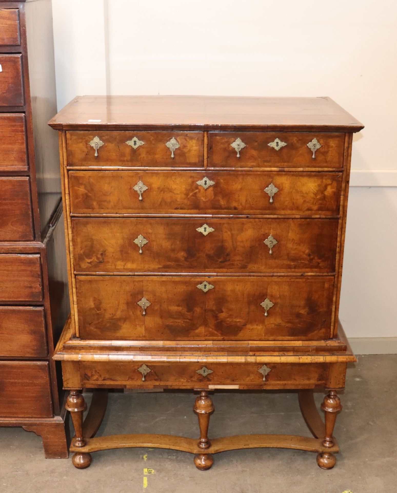 An 18th century walnut chest on stand, the upper section fitted with two short and three long