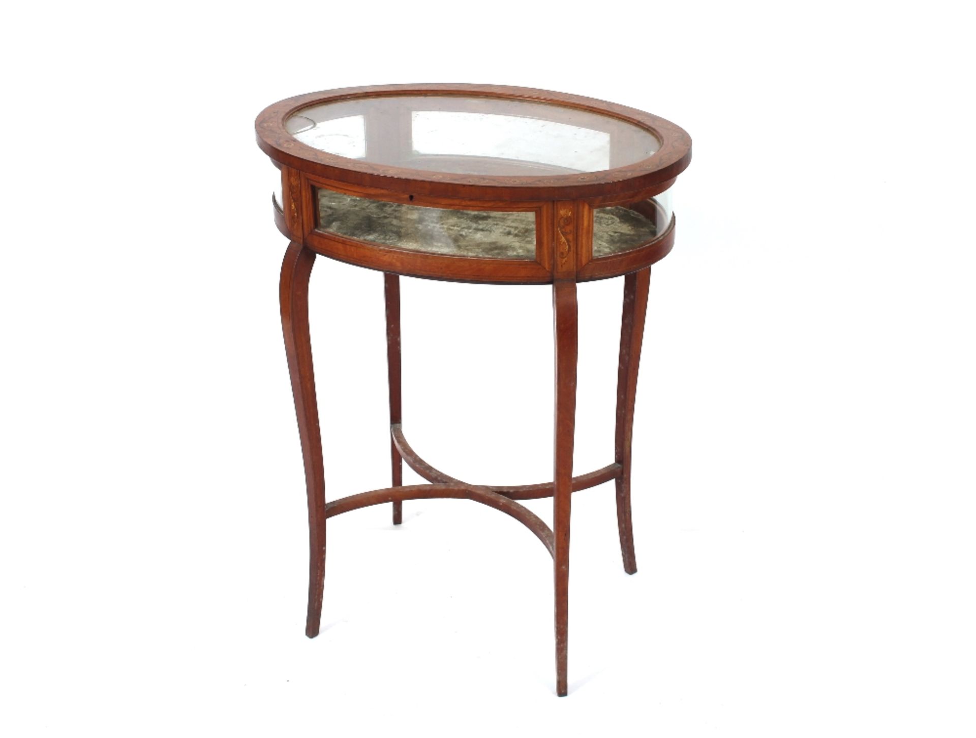 An Edwardian painted satinwood oval curio cabinet raised on bowed supports united by an under