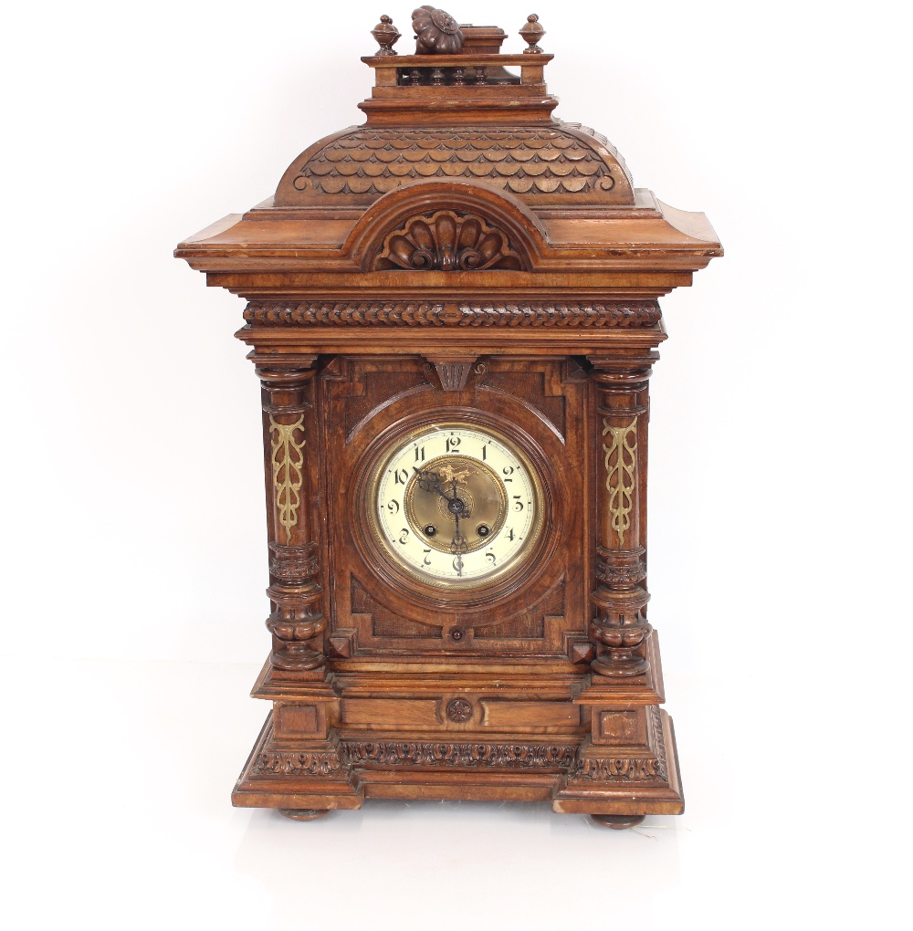 A late Victorian walnut cased mantel clock, eight