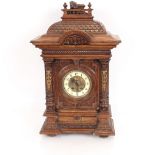 A late Victorian walnut cased mantel clock, eight