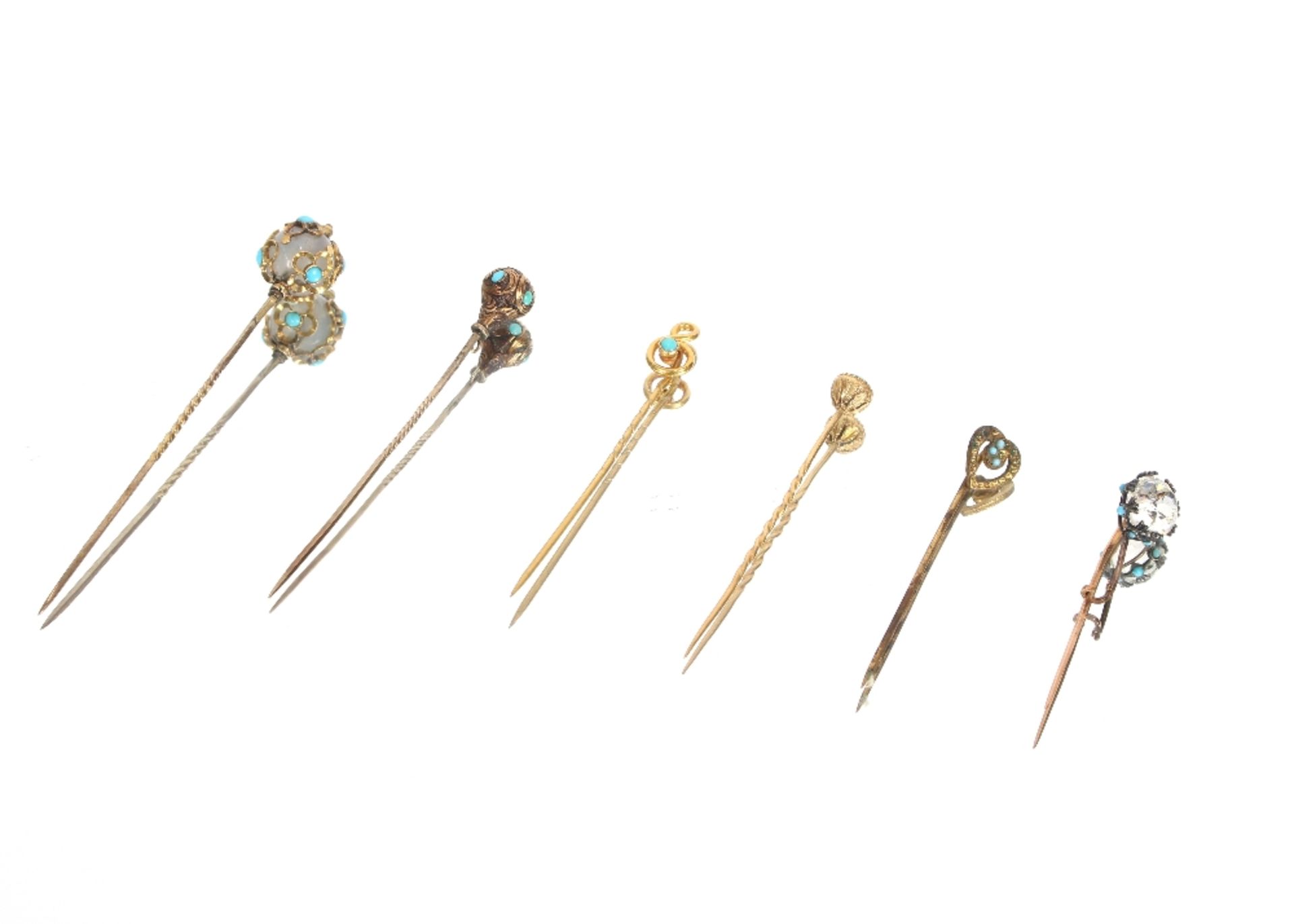 Six yellow metal and turquoise set stick pins