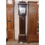 An oak longcase clock with stepped hood enclosing