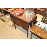 A 19th Century mahogany drop leaf table raised on