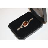 A sterling silver and amber set brooch