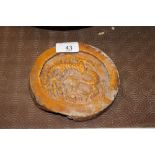 An early glazed Earthenware plaque with raised bea