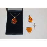 A sterling silver and amber set locket hung to fin