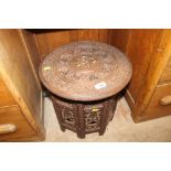 An Indian folding circular topped side table with