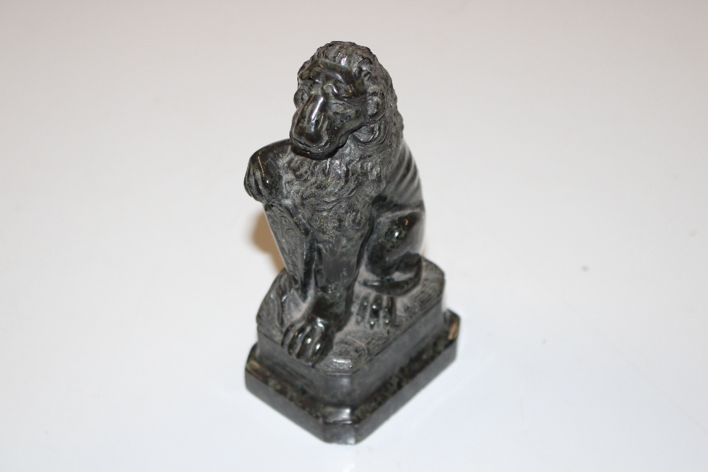 A carved stone ornament in the form of a lion