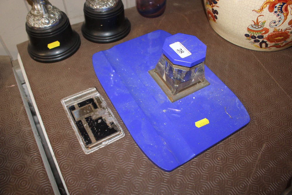 A blue glass desk stand with matching ink well tog