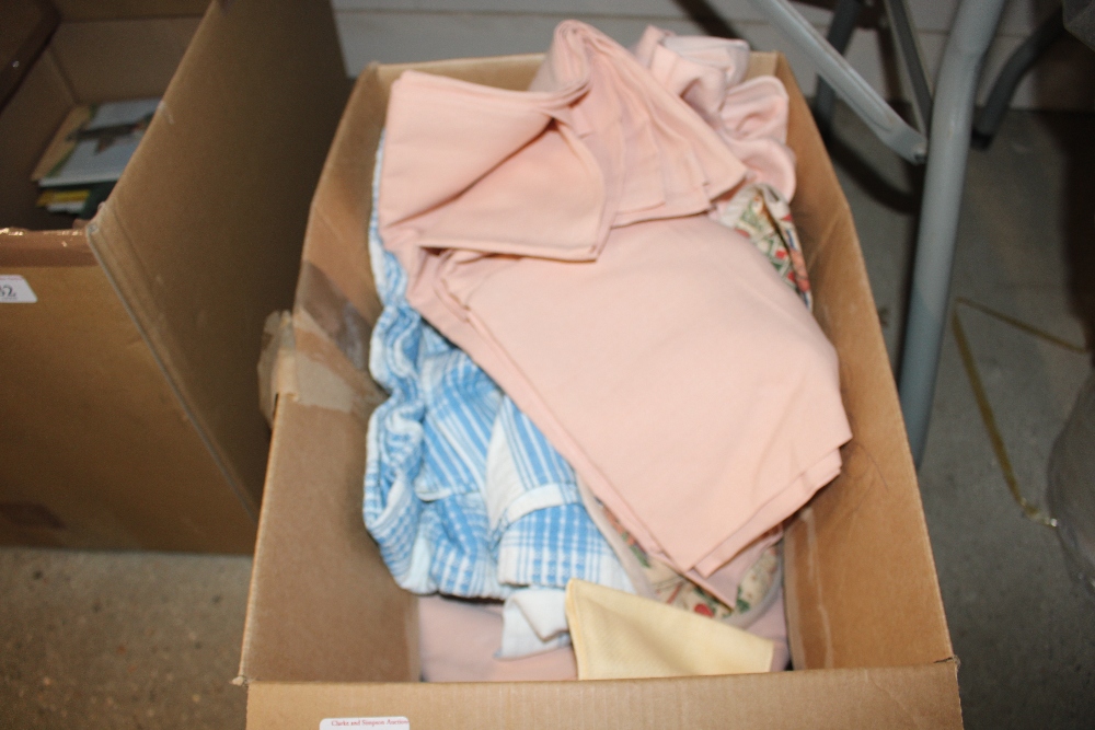 A box containing pink linen sheets