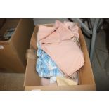 A box containing pink linen sheets