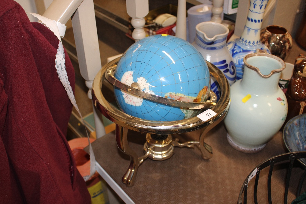 A decorative globe on brass stand
