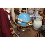 A decorative globe on brass stand