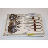 A set of six Polish silver plated spoons with ambe