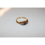 An 18ct gold ring set diamonds and red stones, 4g total weight, ring size N