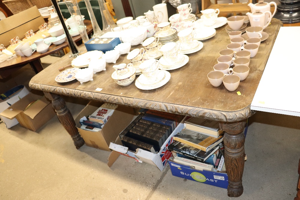 A Victorian carved extending dining table with ext