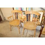 A pair of pine spindle back kitchen elbow chairs