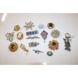 A box of vintage and other costume brooches