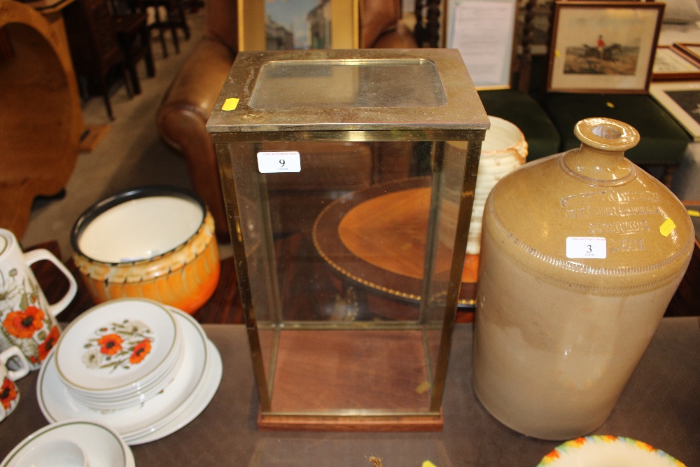 A brass and glass table top display case