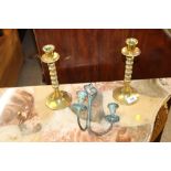 A pair of brass candle sticks and a candle sconce