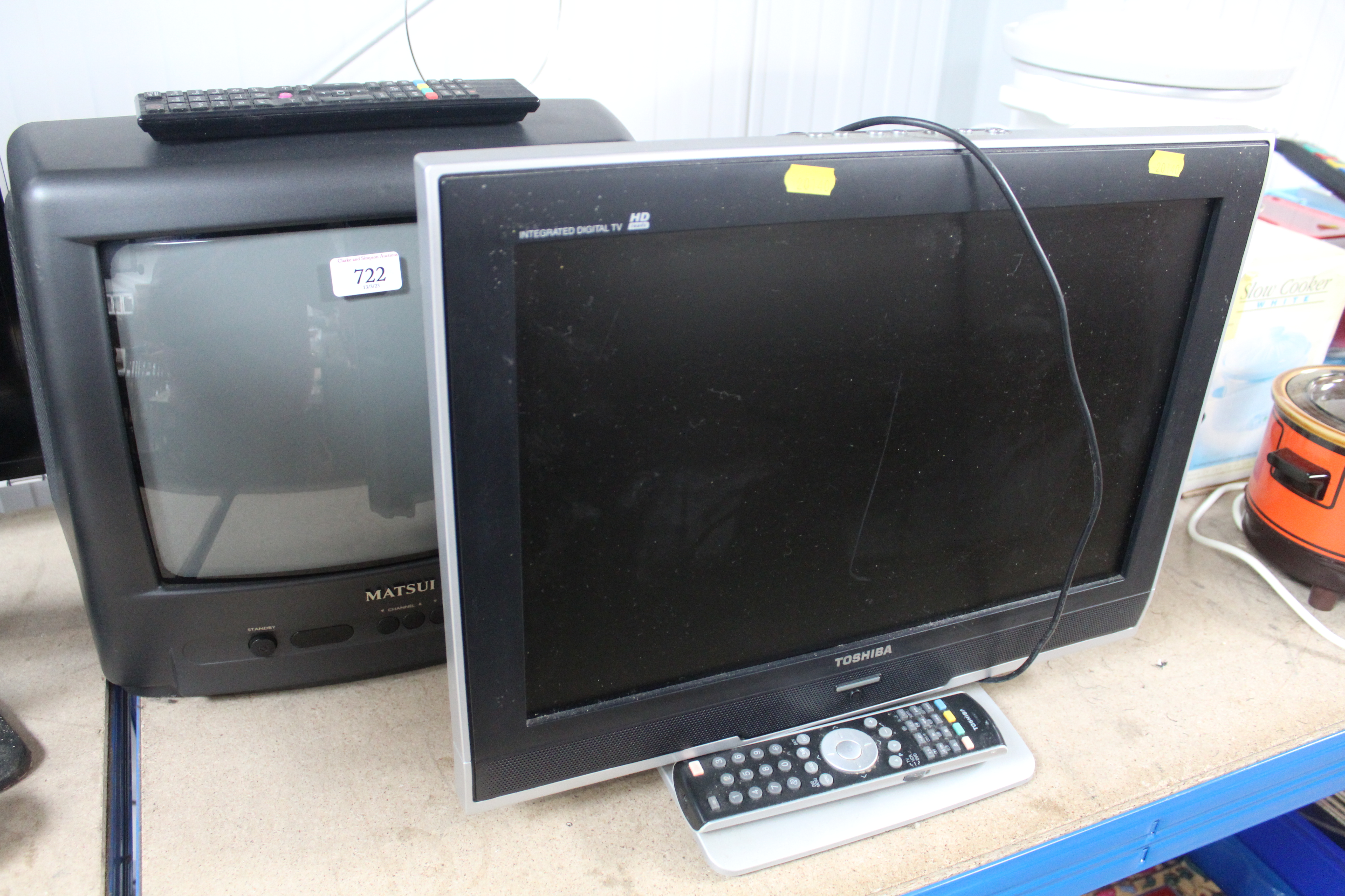 A Matsui television with remote control and a Toshiba tv with remote..