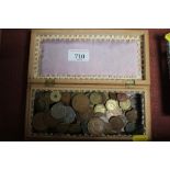 A wooden box and contents of various coinage