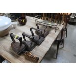 Four flat irons and a trivet