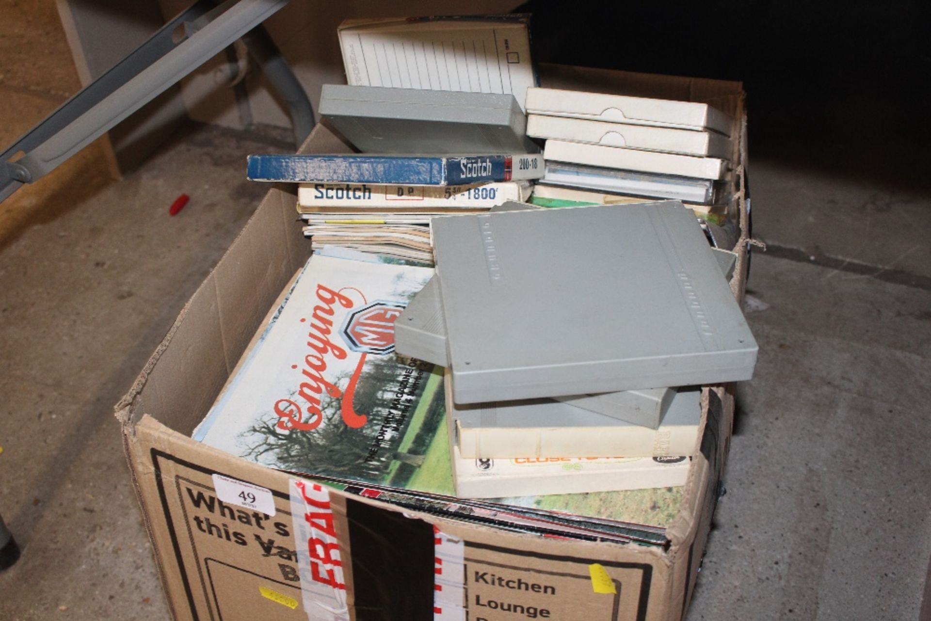 A box of miscellaneous motoring magazines, tapes e