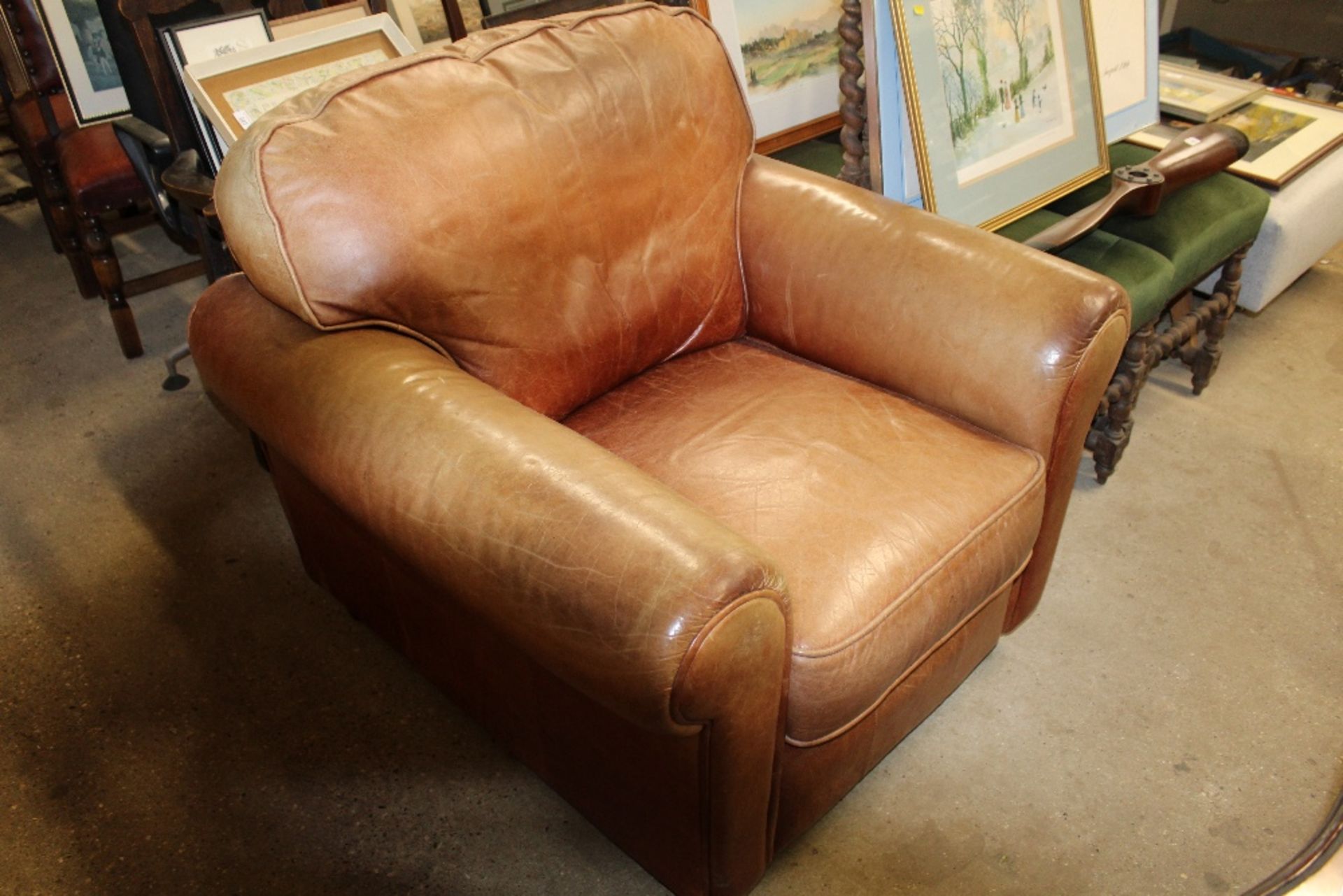 A tan leather deep seated easy chair