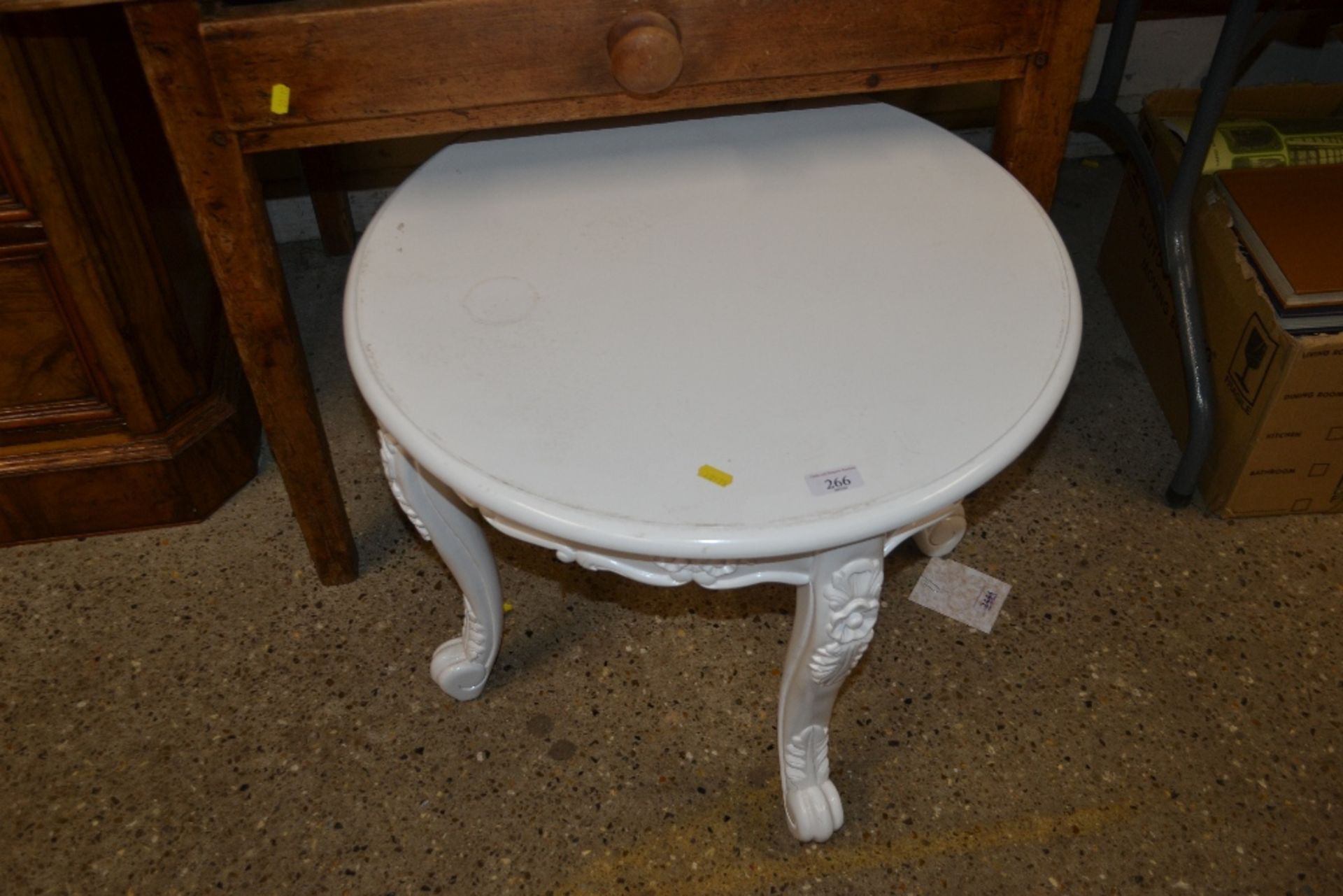 A white painted decorative coffee table raised on
