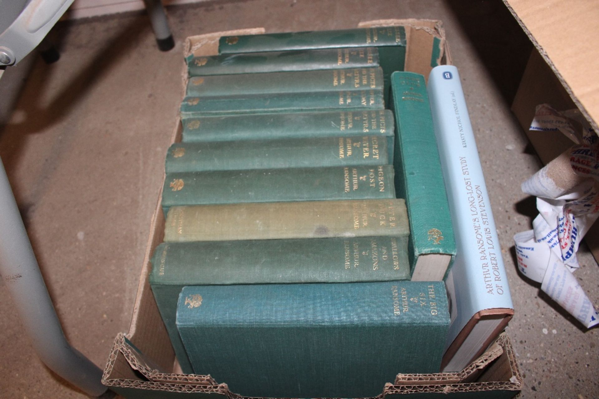 A box of books, mostly Arthur Ransome