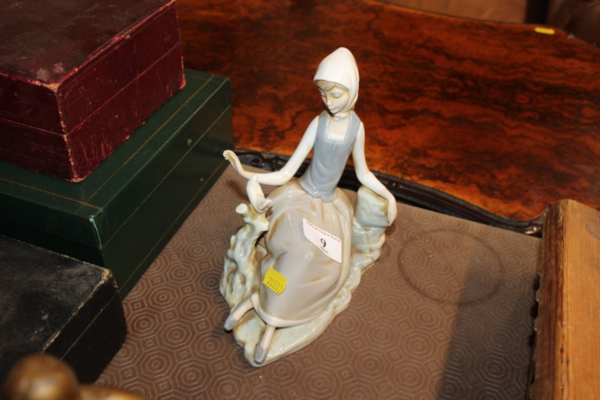 A Lladro figure of a seated girl