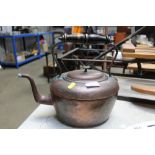 A copper kettle with brass handle