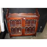 An oak and leaded glazed hanging cabinet