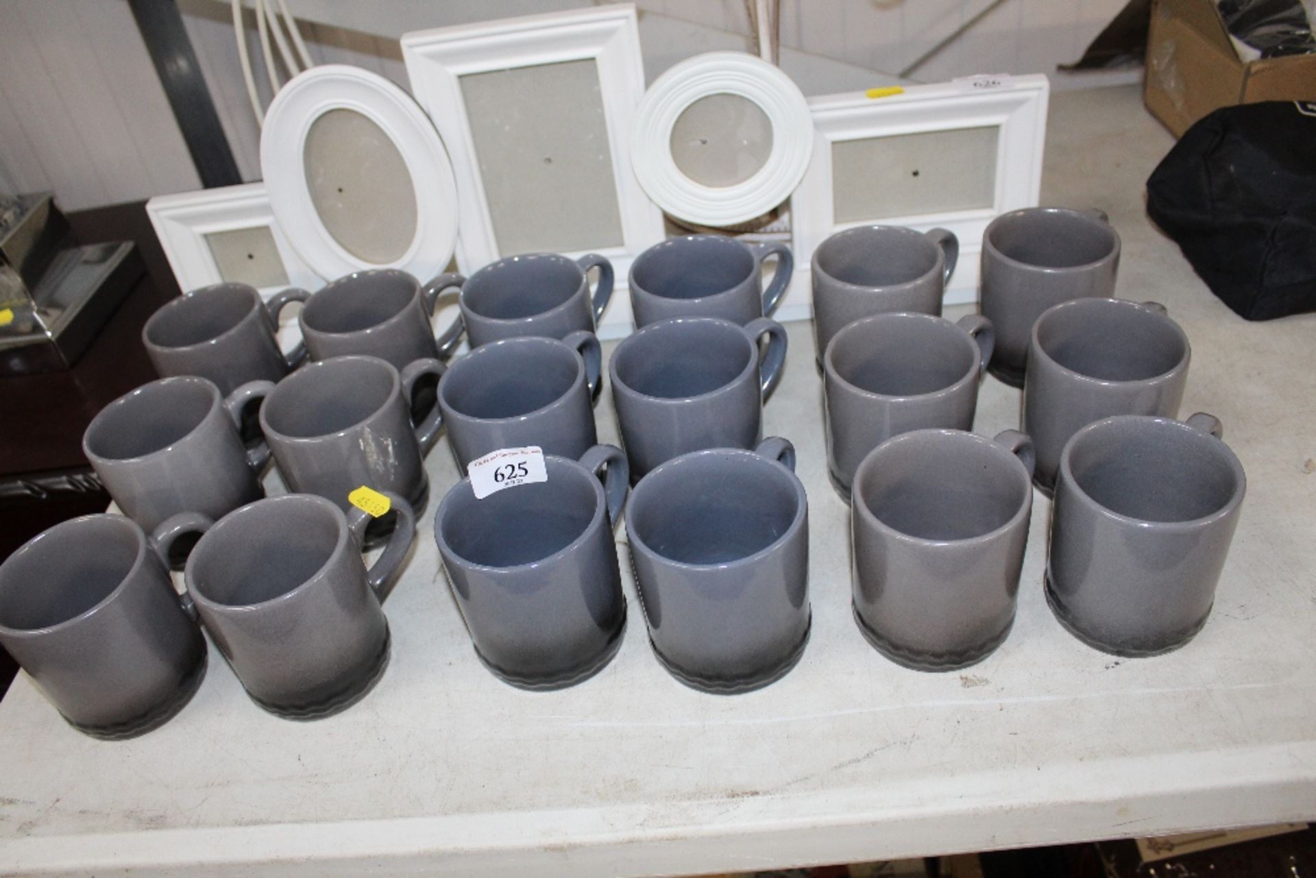 A quantity of grey glazed mugs