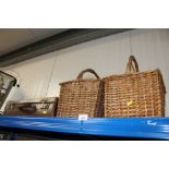 A leather suitcase together with two wicker basket