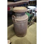 A vintage twin handled milk churn