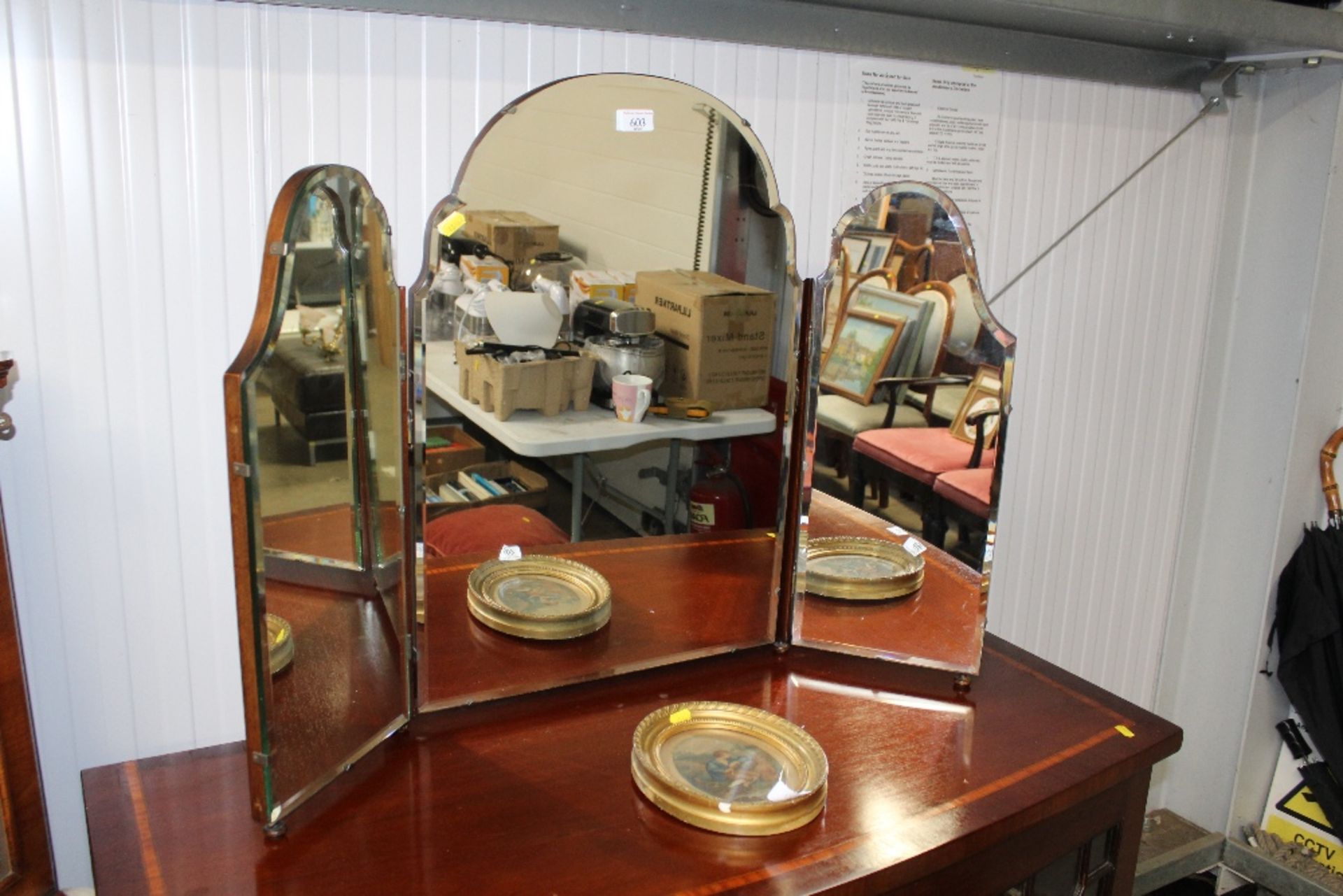 A mahogany and bevelled edge triptych mirror