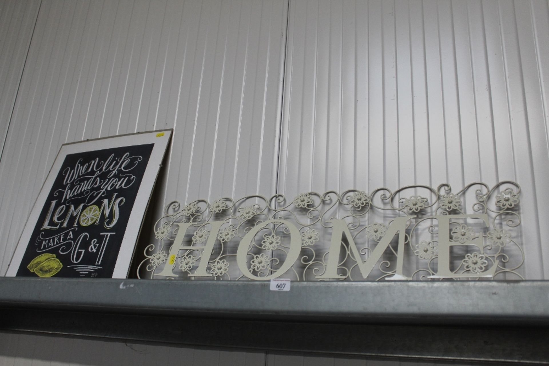 A metal wall hanging "Home" together with a colour