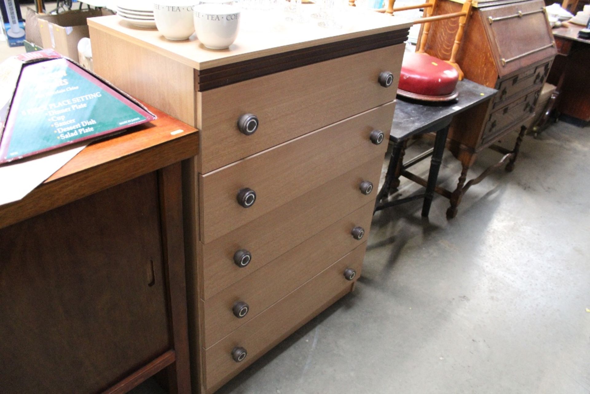 A wood effect chest fitted five drawers