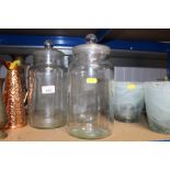 Four glass storage jars